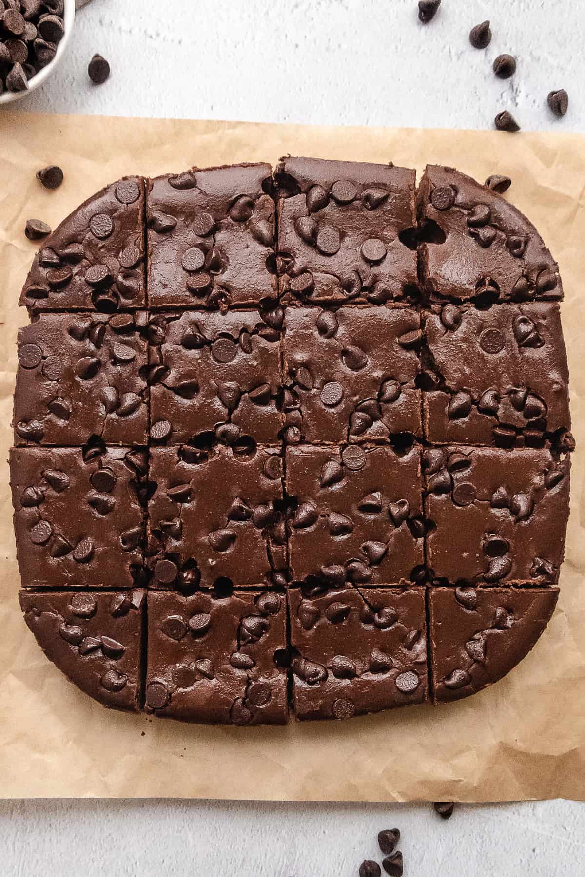 sliced brownies with chocolate chips on parchment paper