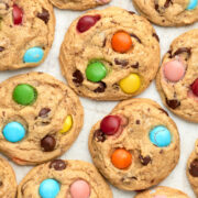 close up of vegan m&m cookies on a baking tray.