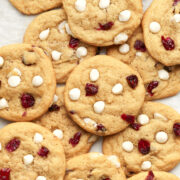 close up of vegan white chocolate cranberry cookies on baking tray.