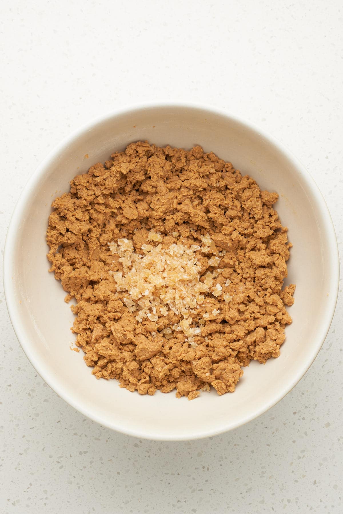 ginger cookie dough with chopped crystallized ginger in a bowl.